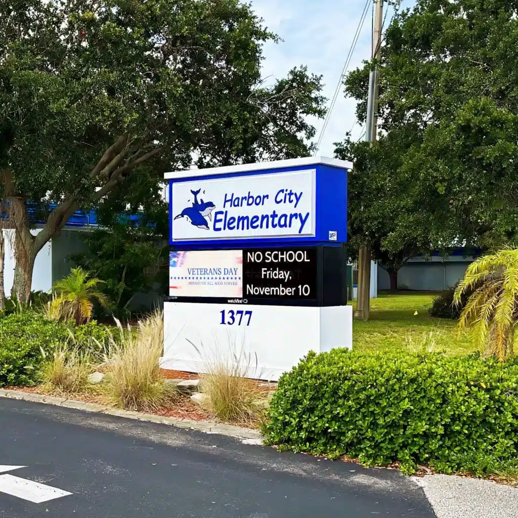 Monument sign for Harbor City Elementary School featuring a 10MM Watchfire LED school sign displaying a Veterans Day message and a no school notice for Friday, November 10.